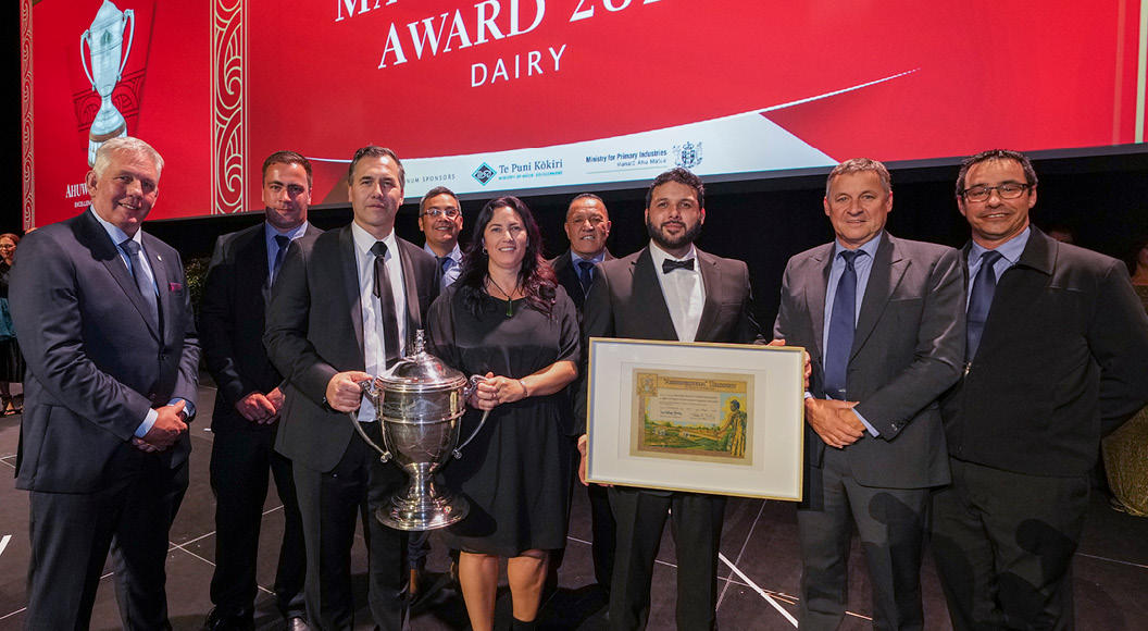Ahuwhenua Trophy 2024 award winners Wairarapa Moana ki Pouākani Incorporation with the trophy and certificate on the stage.